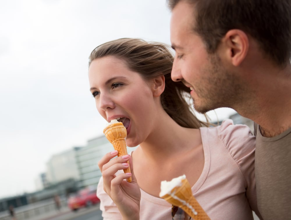 Happy couple enjoying an ice cream on a date